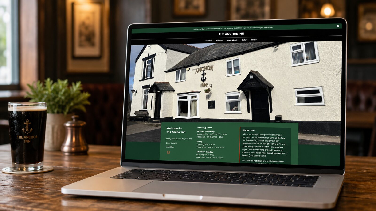 The Anchor Inn website shown on a laptop in the pub